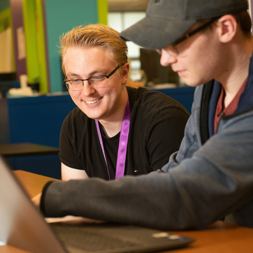 A student receives tutoring in Ross Hall.