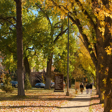 Students walking past Knight Hall on Ivinson Ave side.