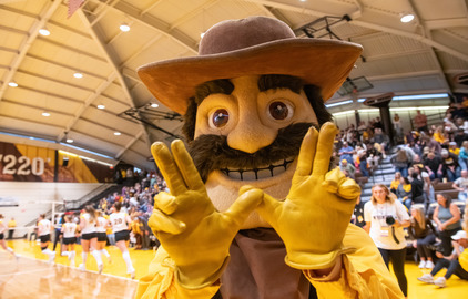 Pistol Pete, the UW mascot, cheers on the volleyball team.