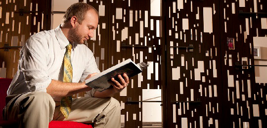 Student reading a book in the Education Annex