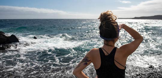 A study abroad student looks at the ocean.