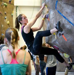 A student climbs at the Half Acre climbing wall.