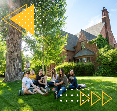 Students sitting on the grass in a group