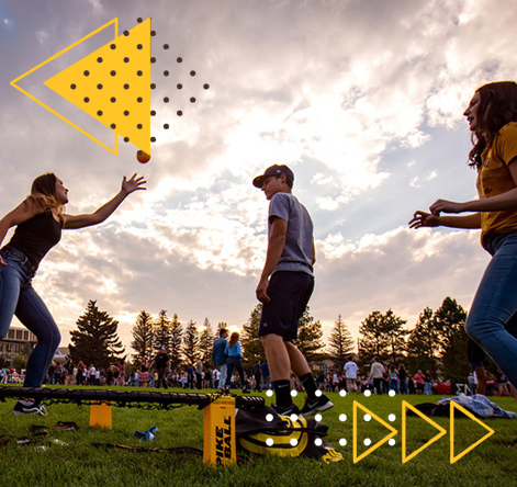 Students playing handball on the grass