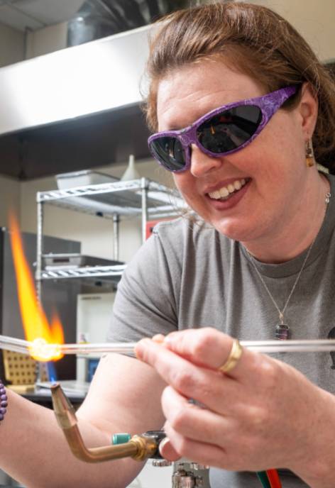 A young man at a blow torch, named Dori Wolfe