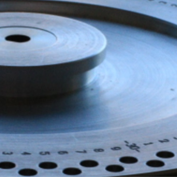 A metal disc with holes for samples. As the disc rotates a sample is dropped into the machine and data is collected.