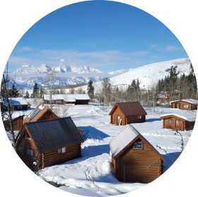 Distant Teton range and snow-covered Kelly Campus of TSS cabins in the foreground