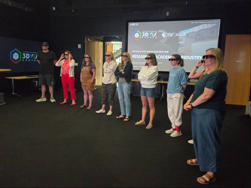 A group of teachers and students enjoying the 3DViz Center.
