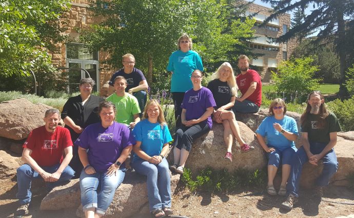 MSC and MMA program students during summer program perched on boulders on Laramie campus