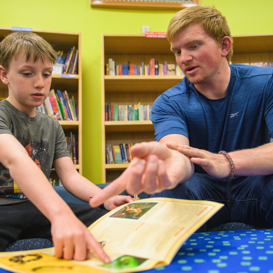 A UW student helping a young child in the Literacy Research Center and Clinic