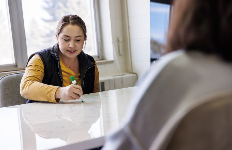 Person taking notes at a table