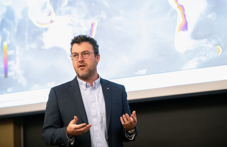 Professor lecturing in front of screen