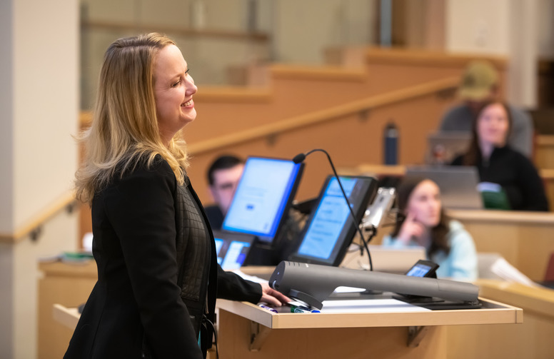 Professor lecturing behind a podium