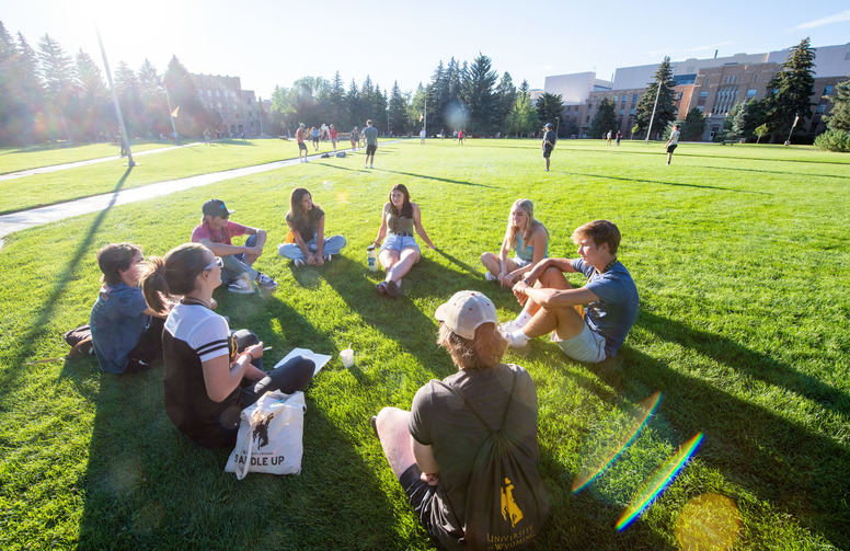 A group of students sit together on Prexy's Pasture