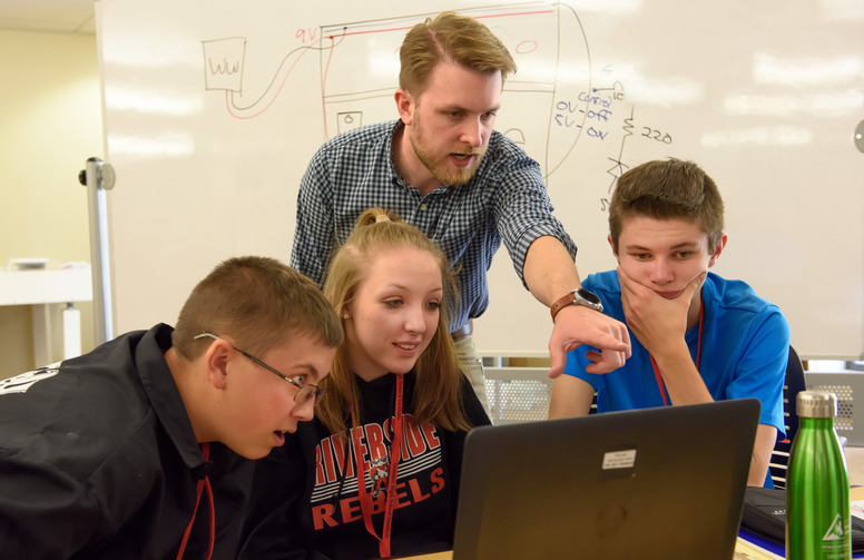 a UW student helping youths in a lab