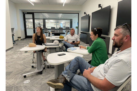 4 people seated in Data X Studio