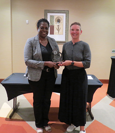 Two people standing for an awards ceremony.