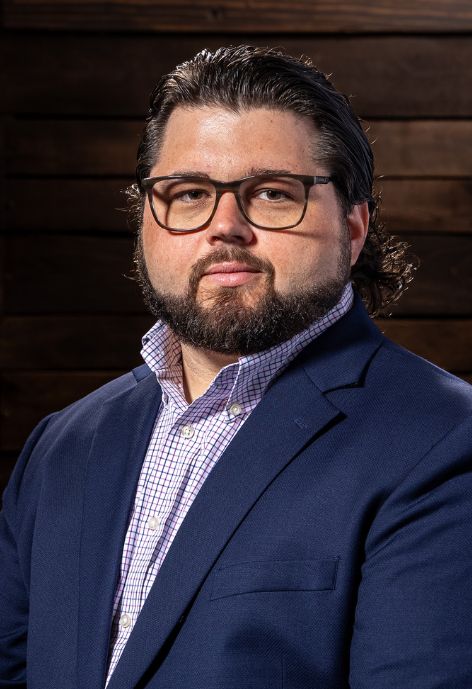 Brandon Folse in front of brick wall