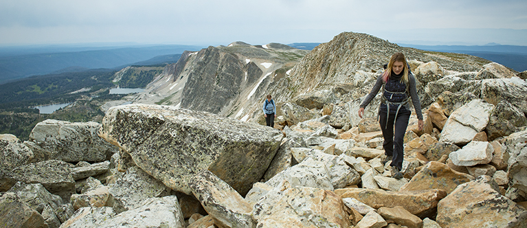 2 SPPAIS students climbing a mountain in their study abroad