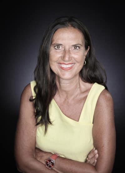 A photo of Federiga Bindi, an Italian woman wit h dark hair wearing a yellow shirt