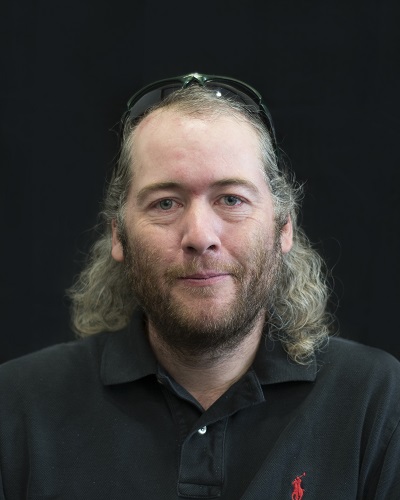 Andrew Garner in front of a black background