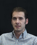 photograph of Dr. Justin Piccorelli in front of a black background