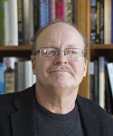photograph of Dr. Thomas Seitz in front of a bookshelf
