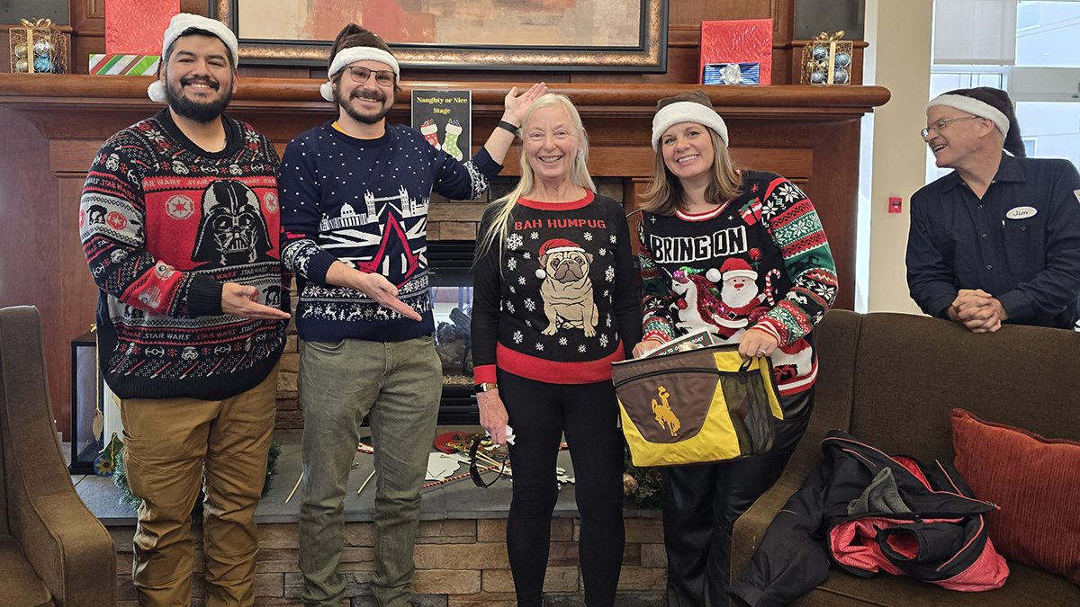 three of our staff senators in "ugly" holiday sweaters celebrating a contest winner