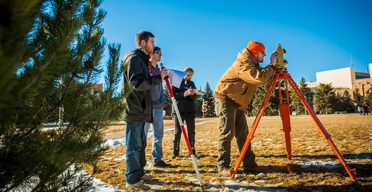 Student surveying on campus