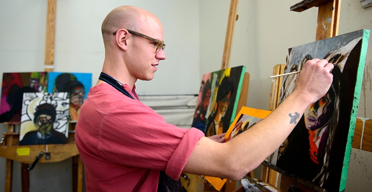 Chancelor Havlik, painting in the senior design studio, Visual Arts building