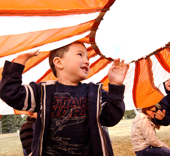 Child playing with a parachute