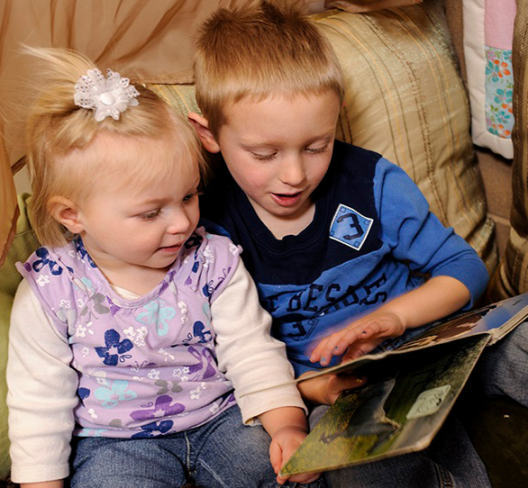 Child reading to another child