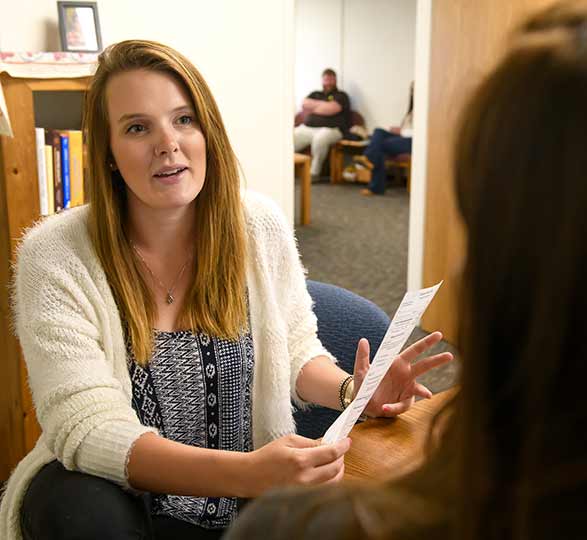 A student speaks with her faculty mentor