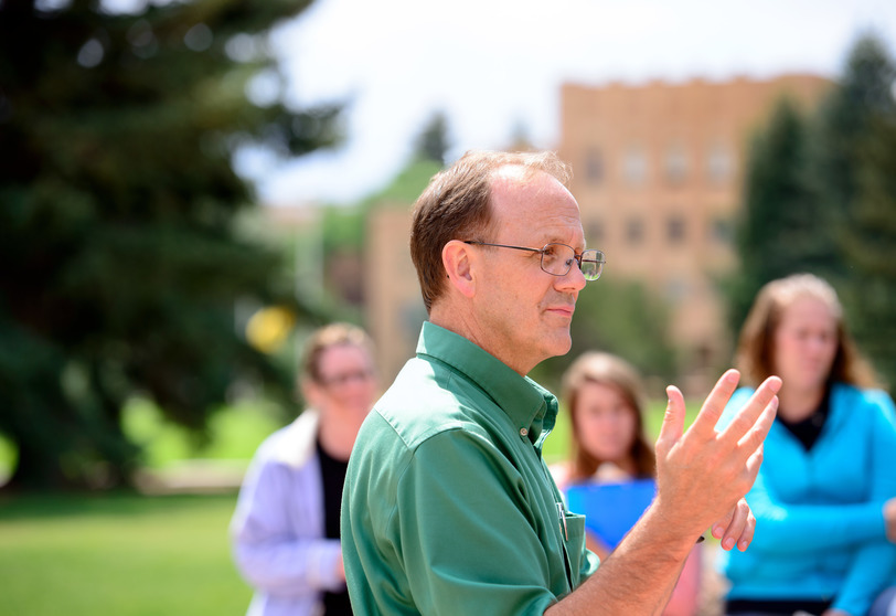 College of Education Faculty Alan Buss instructing a class outside of the Education Building