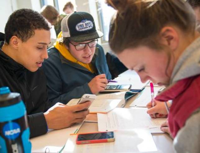 three students work together to study for an assignment