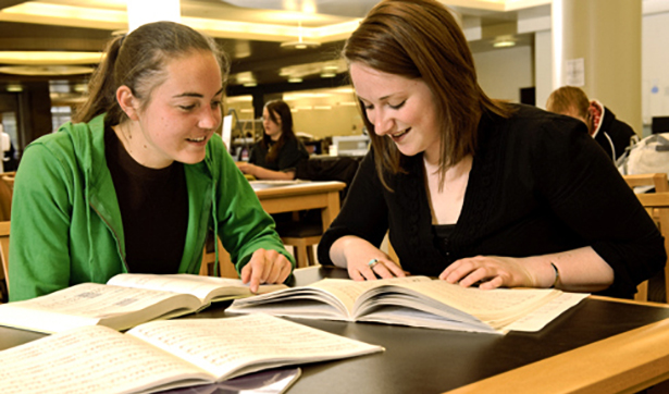 image of two classmates studying together