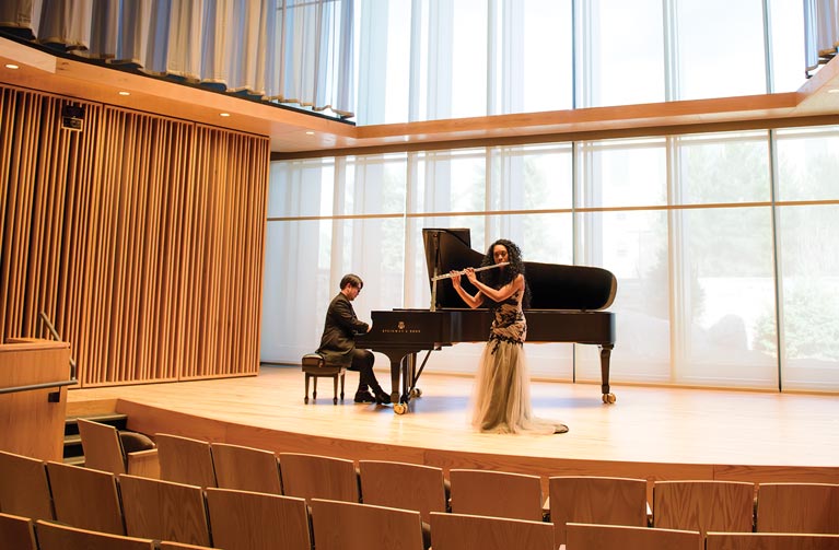a pianist and flautist performing on stage