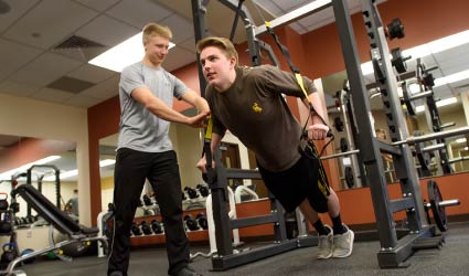 Personal trainer working with student