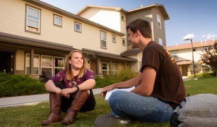 Students sitting outside UW Apartments