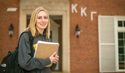 Sorority sister standing outside sorority house