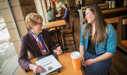 Mentor and student sitting in cafe