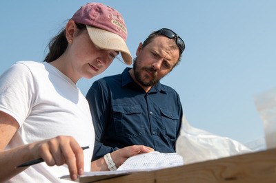 Two people looking at job site map