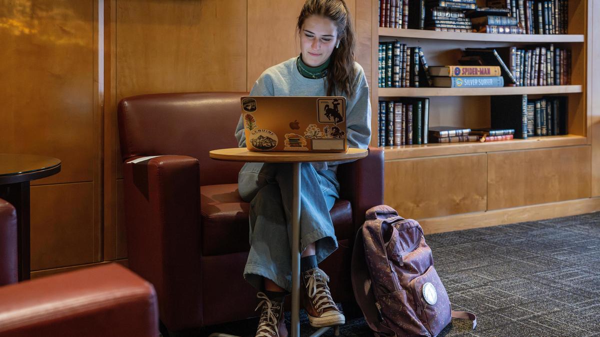 A student sits at a table working on a project in COE Library