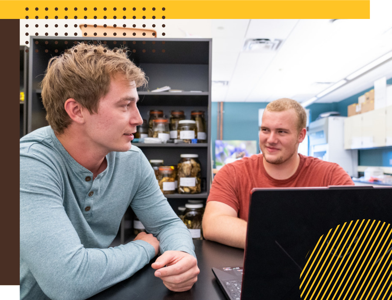 Two students work together on a poject at a laptop