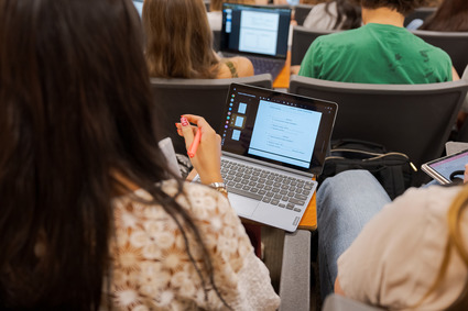 Student with a laptop in class