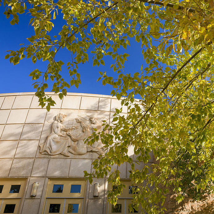 Campus building with an Aspen tree in foreground