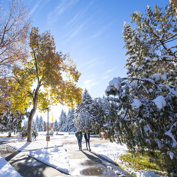 Students walking on campus with snow on ground