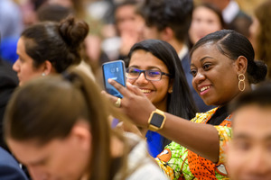 Student showing another student her phone