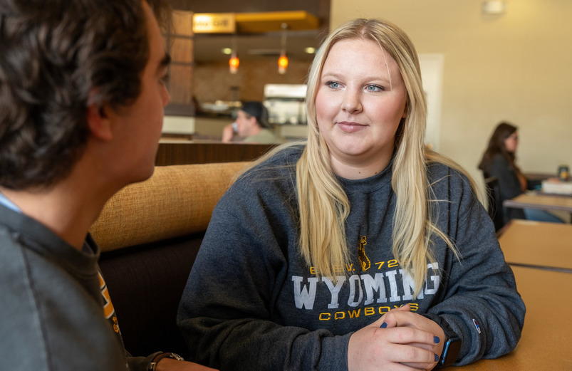 Student and Cowboy Coach eating at a cafe