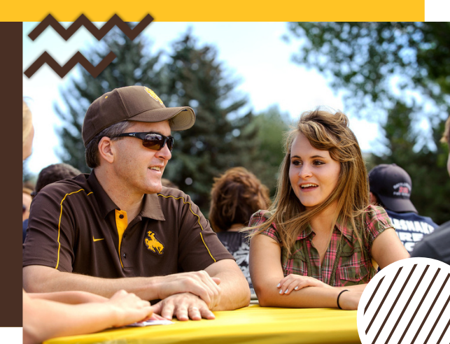 Student sits with her father at Family Weekend